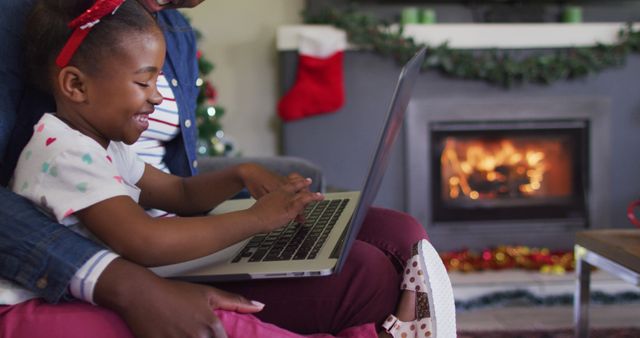 Smiling Girl Using Laptop with Father in Festive Living Room - Download Free Stock Images Pikwizard.com