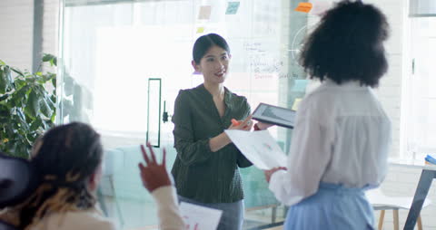 Business Team Collaborating with Tablet Around Meeting Table