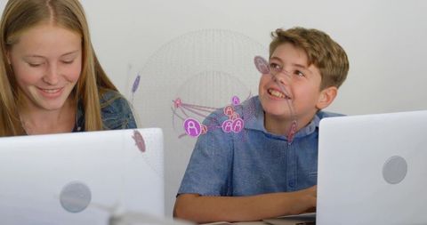 Teens collaborating on laptops with pink network overlay for digital learning and STEM