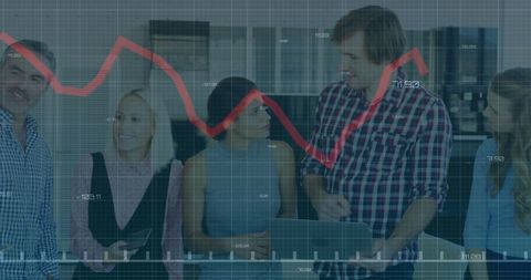Colleagues examining financial data trends in modern office