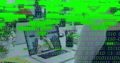 Mature woman wearing eyeglasses typing on laptop at home office with green binary glitch