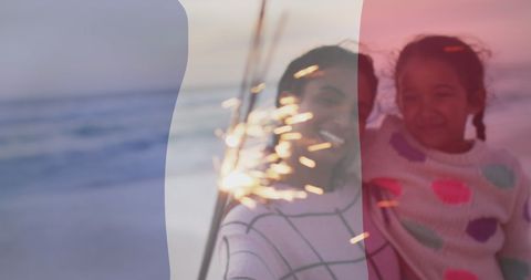 Celebrating French National Day at Beach with Family Sparkler