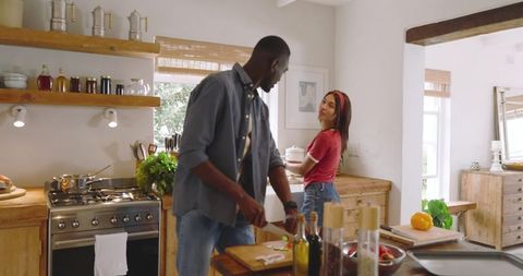 Diverse Couple Cooking Together in Cozy Rustic Kitchen Setting