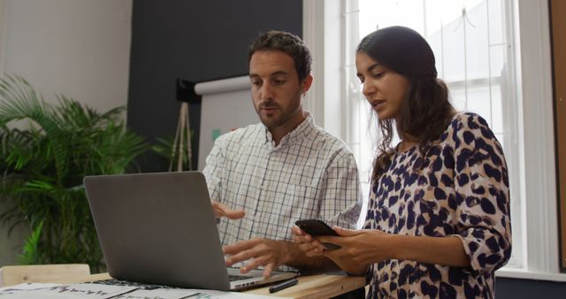 Two professionals collaborating in modern office - Download Free Stock Images Pikwizard.com