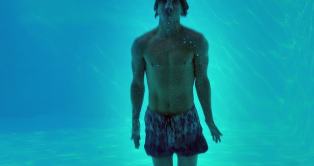 Young man underwater in swimming pool - Download Free Stock Images Pikwizard.com