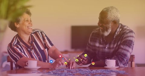 Happy Senior African American Couple Engaging with Social Media Icons