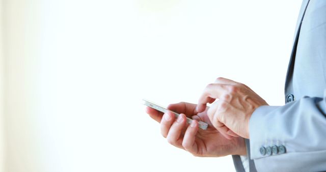 Businessman Using Smartphone in Office Building - Download Free Stock Images Pikwizard.com