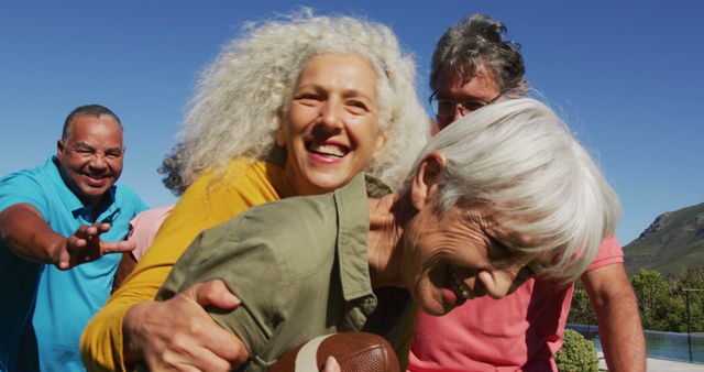 Senior friends playing football outdoors. They are having fun with big smiles on their faces, symbolizing happiness, camaraderie, and an active lifestyle. Great for promoting senior health, active living, friendships, outdoor activities, and mental well-being.