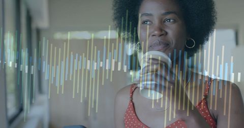 African American Woman Analyzing Data on Transparent Interface