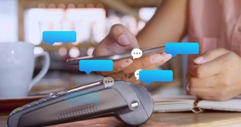 Making contactless mobile payment in cafe, hands tapping smartphone with pos card reader