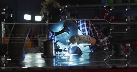 Female welder performing precision tig welding at industrial workbench with hud overlay