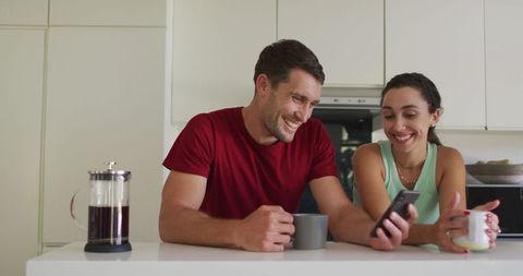 Couple Enjoys Coffee Together While Using Smartphone at Home - Download Free Stock Images Pikwizard.com
