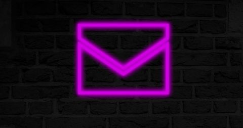 Glowing Neon Envelope on Brick Wall