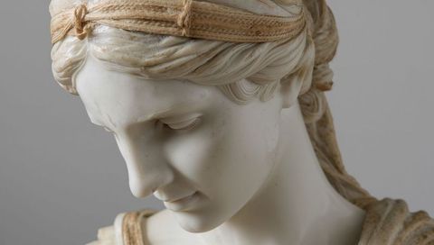 Neoclassical marble bust with woven headband, sculpted drapery and gentle patina