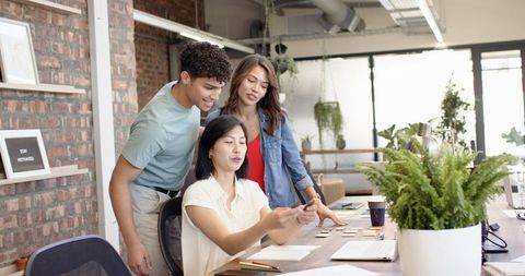 Team Collaboration in Modern Open-Plan Office with Tech Gadgets