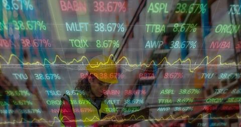 Female Worker Analyzing Data in Warehousing with Digital Overlay