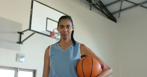 Confident African American Woman Holding Basketball Indoors