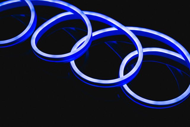 Illustration of illuminated blue neon spiral design against black background. Copy space, vector, abstract, glowing, pattern and gradient concept.