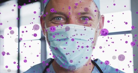 Smiling masked doctor wearing surgical cap and stethoscope protecting patients from pathogens