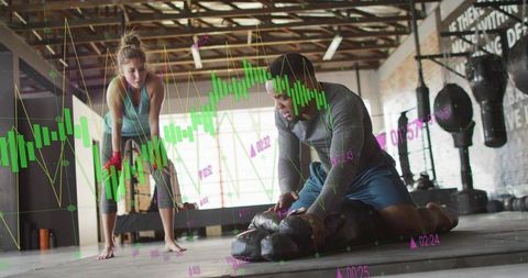 Cpr instructor compressing manikin while trainee observing in gym with financial data overlay