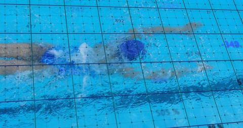 Athlete swimming in pool with tracking data technology