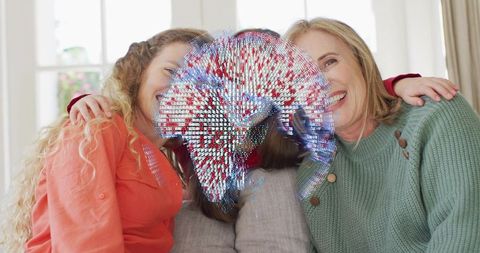 Three-generation family hugging on couch with digital mosaic overlay showing global bond