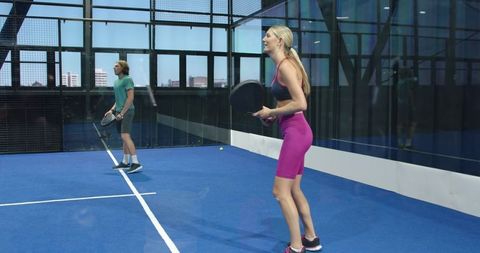Diverse Friends Enjoying Padel Match on Urban Rooftop Court