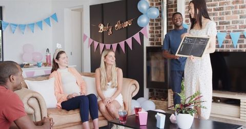 Friends Laughing and Playing Games at Baby Shower Celebration