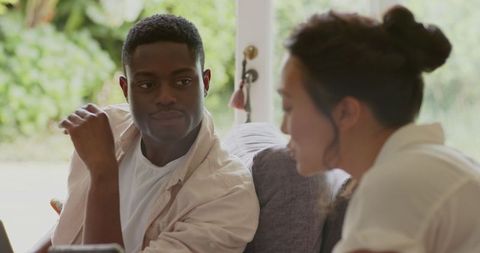 Diverse teamwork in casual home setting with digital technology