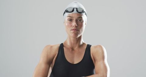 Confident Female Swimmer Adjusting Goggles Before Swimming