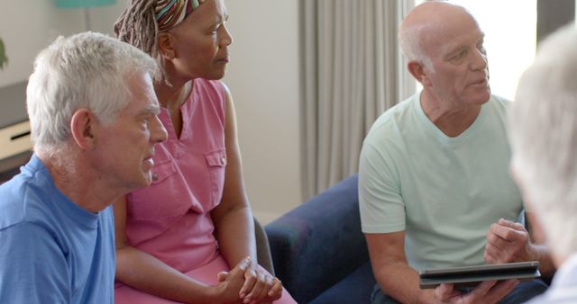 Group of Seniors Engaging in Discussion with Tablet - Download Free Stock Images Pikwizard.com