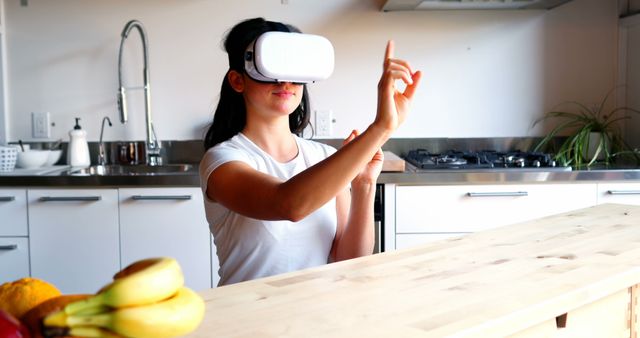 Woman using virtual glasses in kitchen