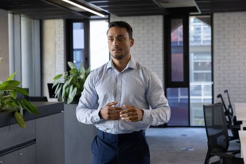 Confident Businessman in Modern Open Office with Greenery