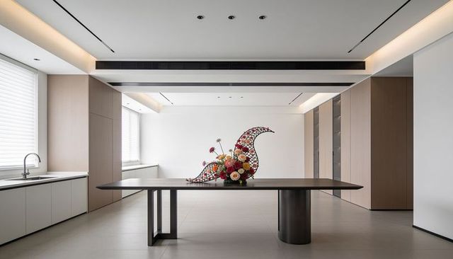 Modern minimalist kitchen with crescent lattice sculpture and vibrant floral arrangement