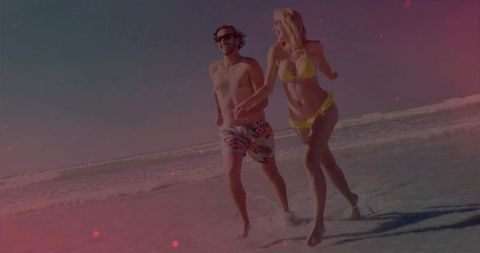 Couple Enjoying A Playful Day On A Vibrant Seaside Shoreline