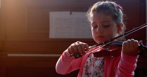 Focused Young Girl Practicing Violin in Warm Lighting - Download Free Stock Images Pikwizard.com