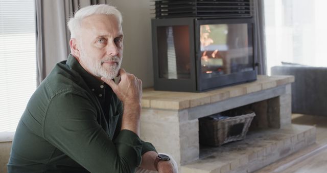 Thoughtful Mature Man Relaxing by Fireplace at Home - Download Free Stock Images Pikwizard.com