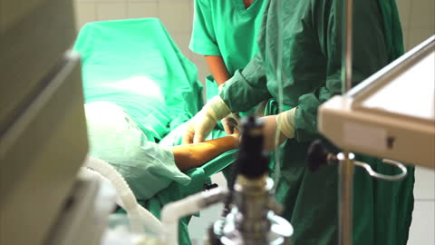 Surgeons Performing Operating Room Procedure on Patient