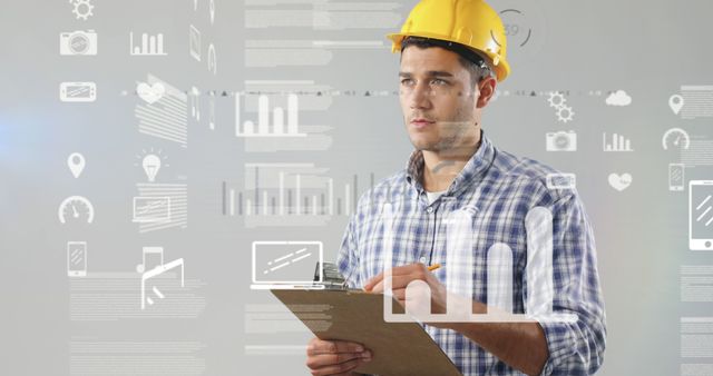 Young engineer wearing yellow hard hat and holding clipboard, planning project details by analyzing data visuals on transparent screen. Suitable for use in articles, advertisements, or materials related to engineering, technology, data analysis, construction projects, productivity tools, and work planning.