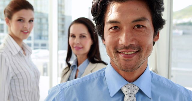 Confident Businessman Smiling with Diverse Colleagues in Office - Download Free Stock Images Pikwizard.com