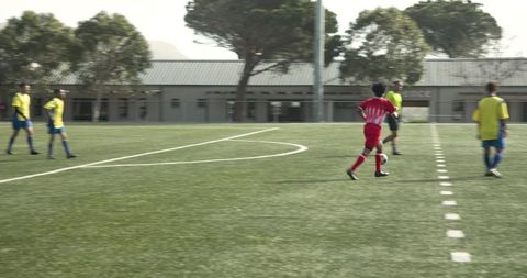 Teen soccer players practicing on field promoting teamwork and unity