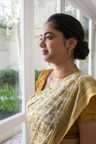 Elegance in Tradition: Woman in Floral Sari Admiring Garden