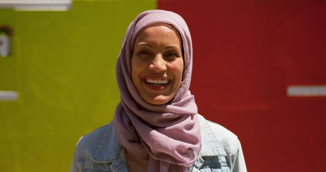 Happy Woman in Hijab Smiling at Multicolored Wall - Download Free Stock Images Pikwizard.com