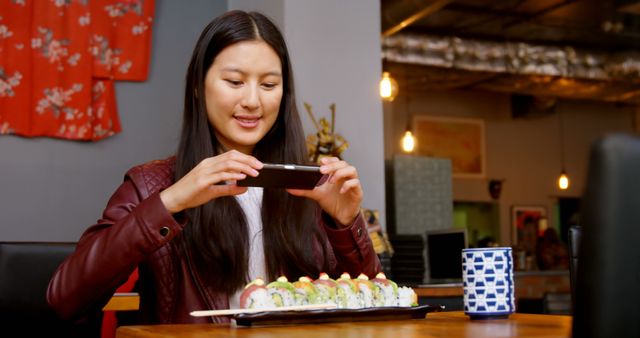 Young Woman Taking Photo of Sushi in Japanese Restaurant - Download Free Stock Images Pikwizard.com