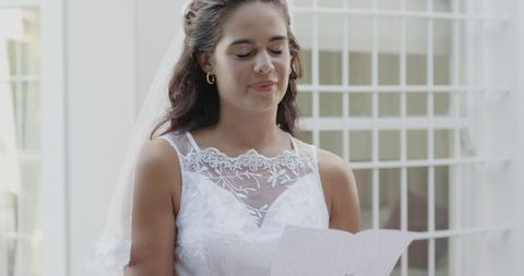 Bride Smiling Joyfully in Elegant White Wedding Dress