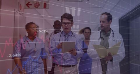 Healthcare Team Analyzing Data Walking in Hospital Corridor