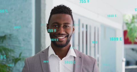 Smiling businessman displaying floating currency and analytics overlays in modern office