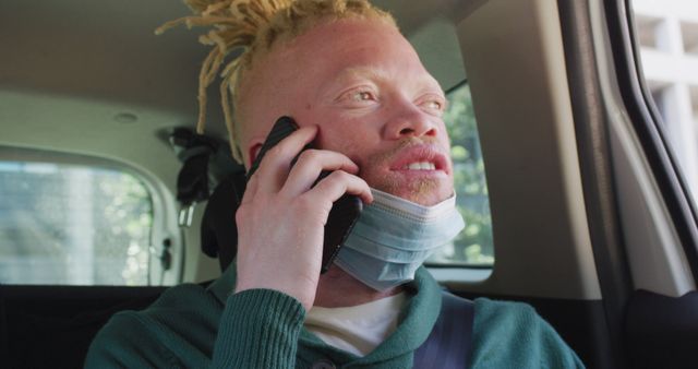 Young Man with Albinism Talking on Smartphone in Car - Download Free Stock Images Pikwizard.com