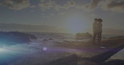 Couple embracing at sunset on coastal pathway