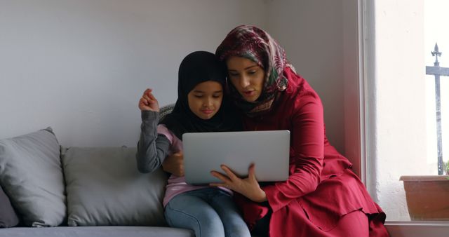 Mother and Daughter Using Laptop on Couch - Download Free Stock Images Pikwizard.com